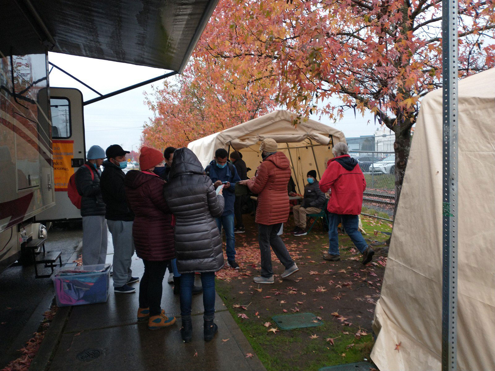AIDNW volunteers gather to help asylum seekers released from detention on a chilly Pacific Northwest fall afternoon.